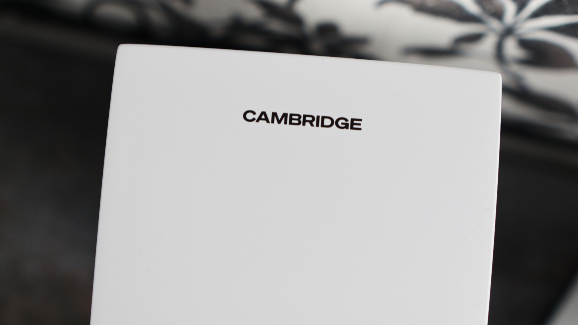 Cambridge Audio's L/R S speakers on a desk. The speakers are white with black tweeters.