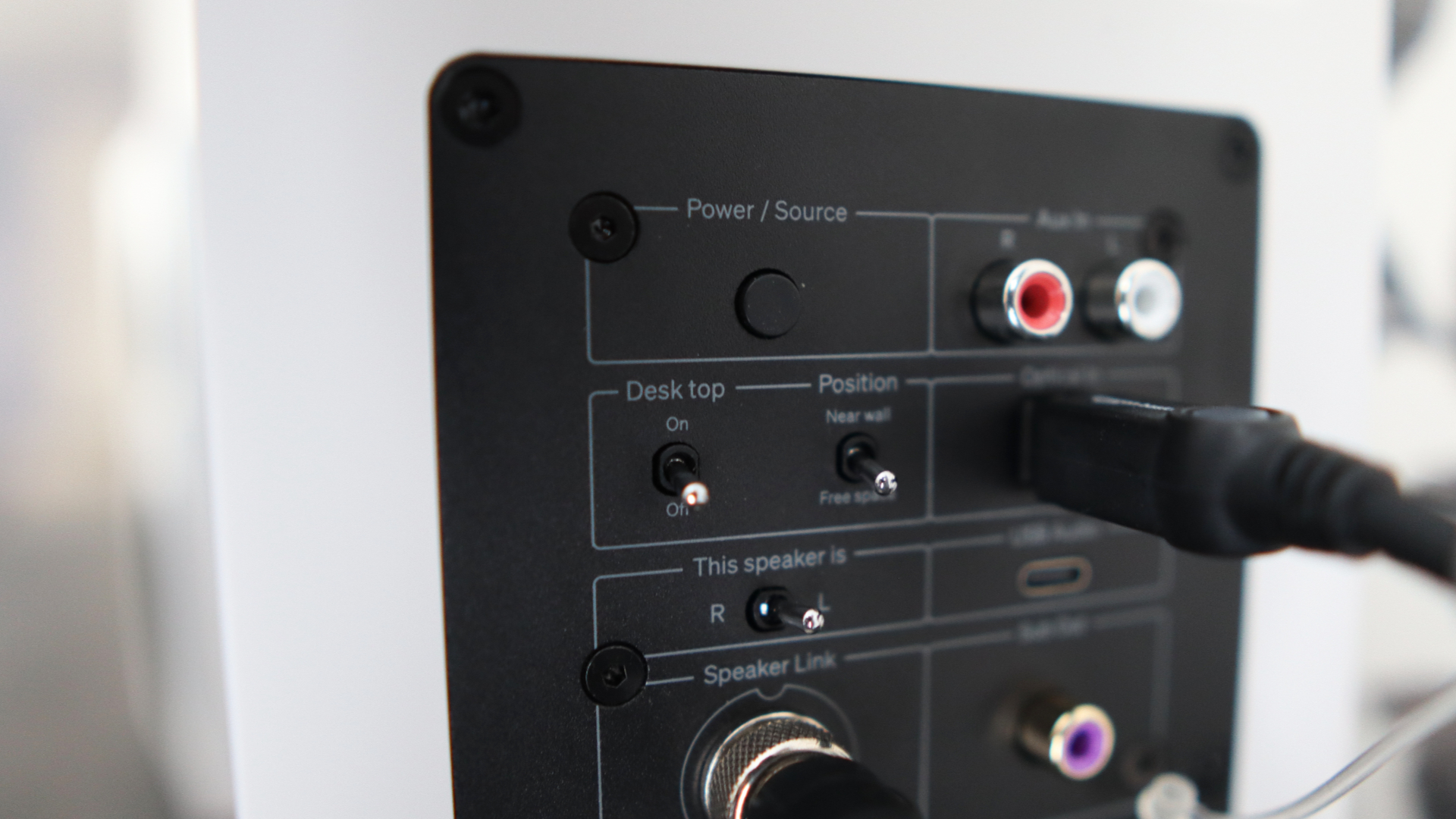 Cambridge Audio's L/R S speakers on a desk. The speakers are white with black tweeters.