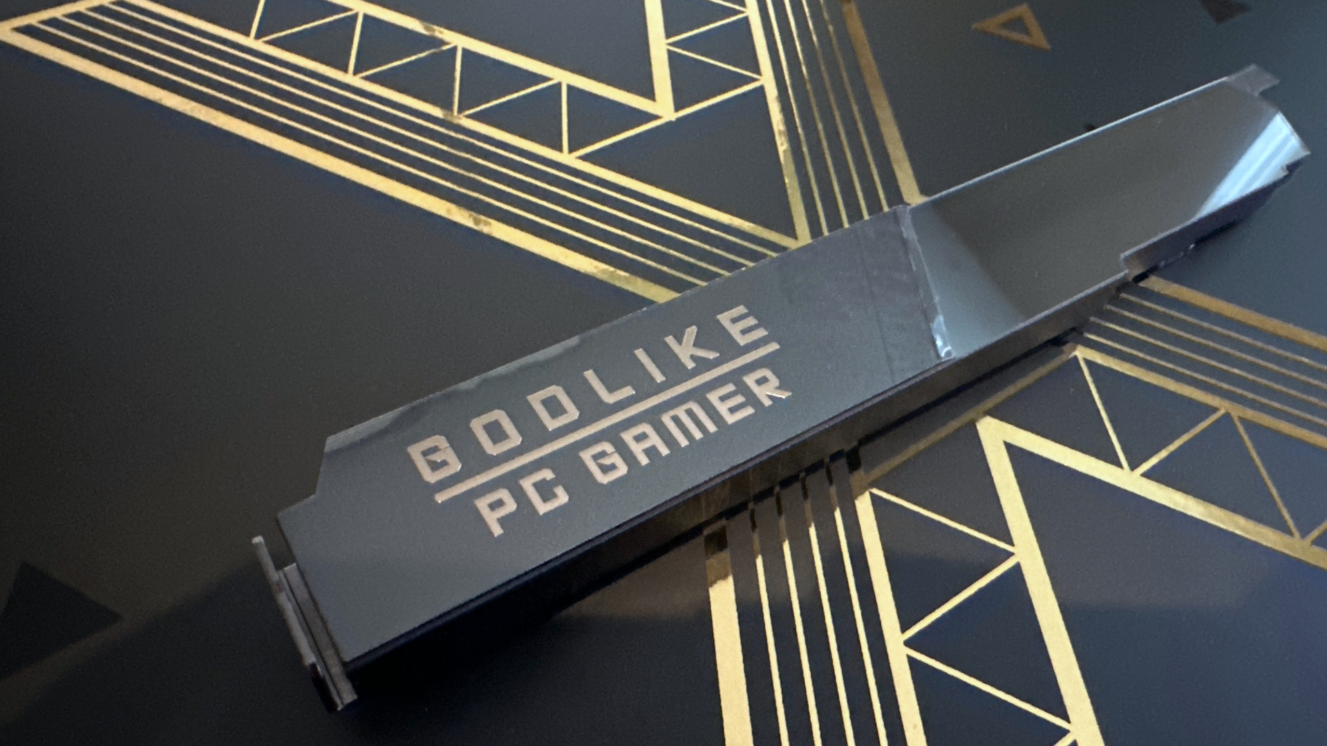 A photo showing the PC Gamer custom M.2 heatsink for an MSI MEG X870E Godlike X Edition motherboard