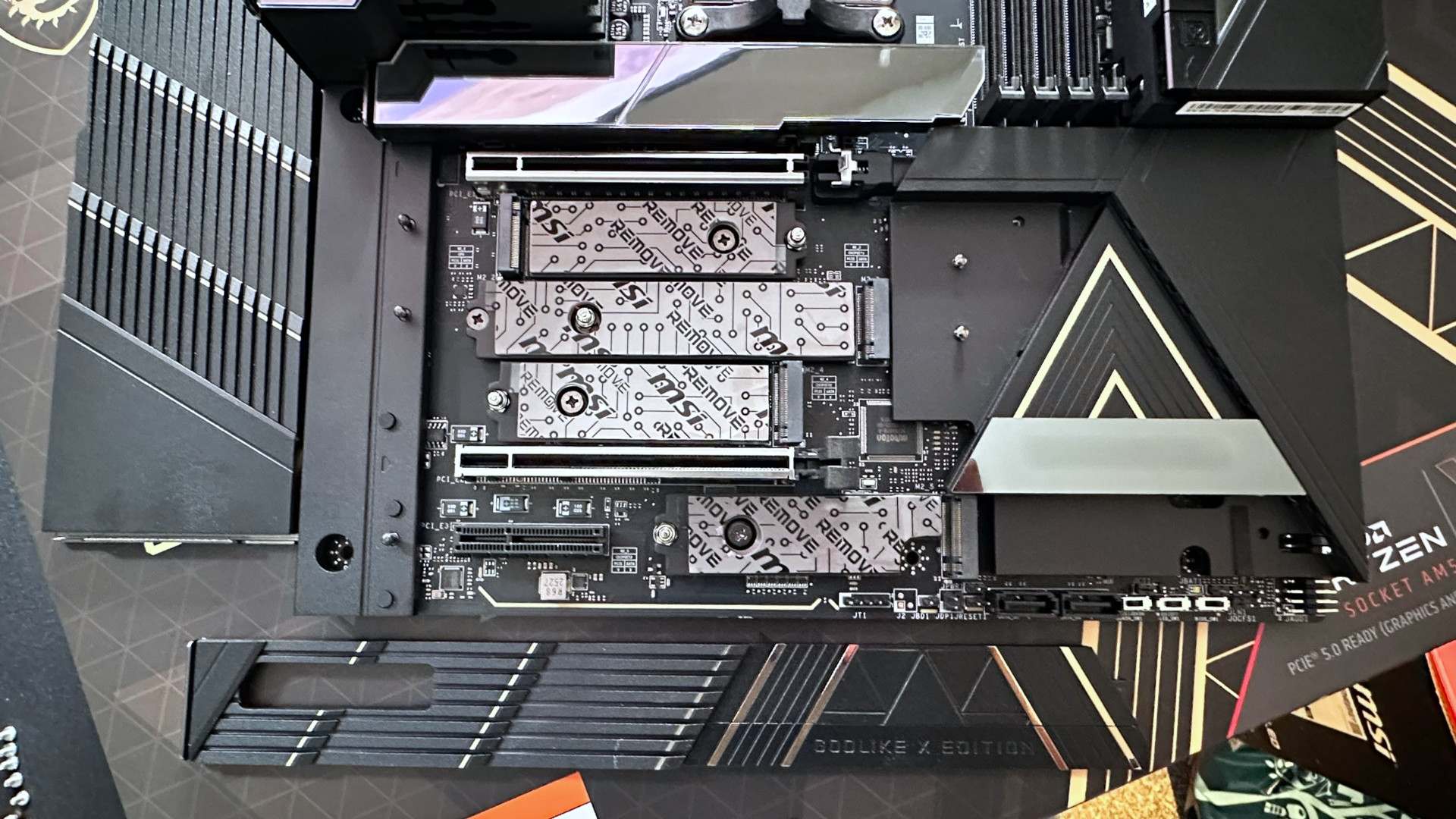A photo showing the lower M.2 slots of an MSI MEG X870E Godlike X Edition motherboard, with its heatsink removed