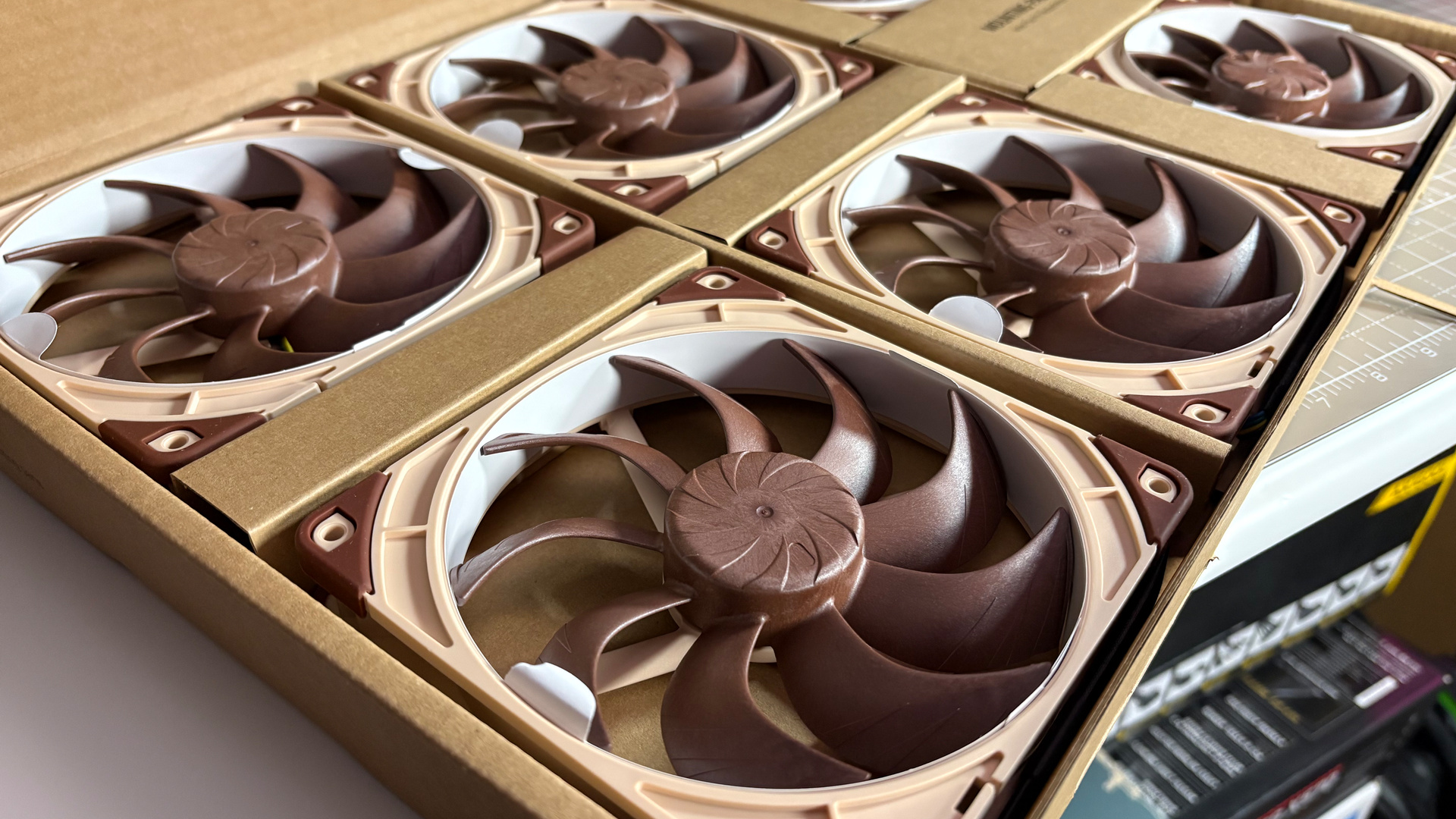 The Antec Flux Pro Noctua Edition on a desk with various parts disassembled.