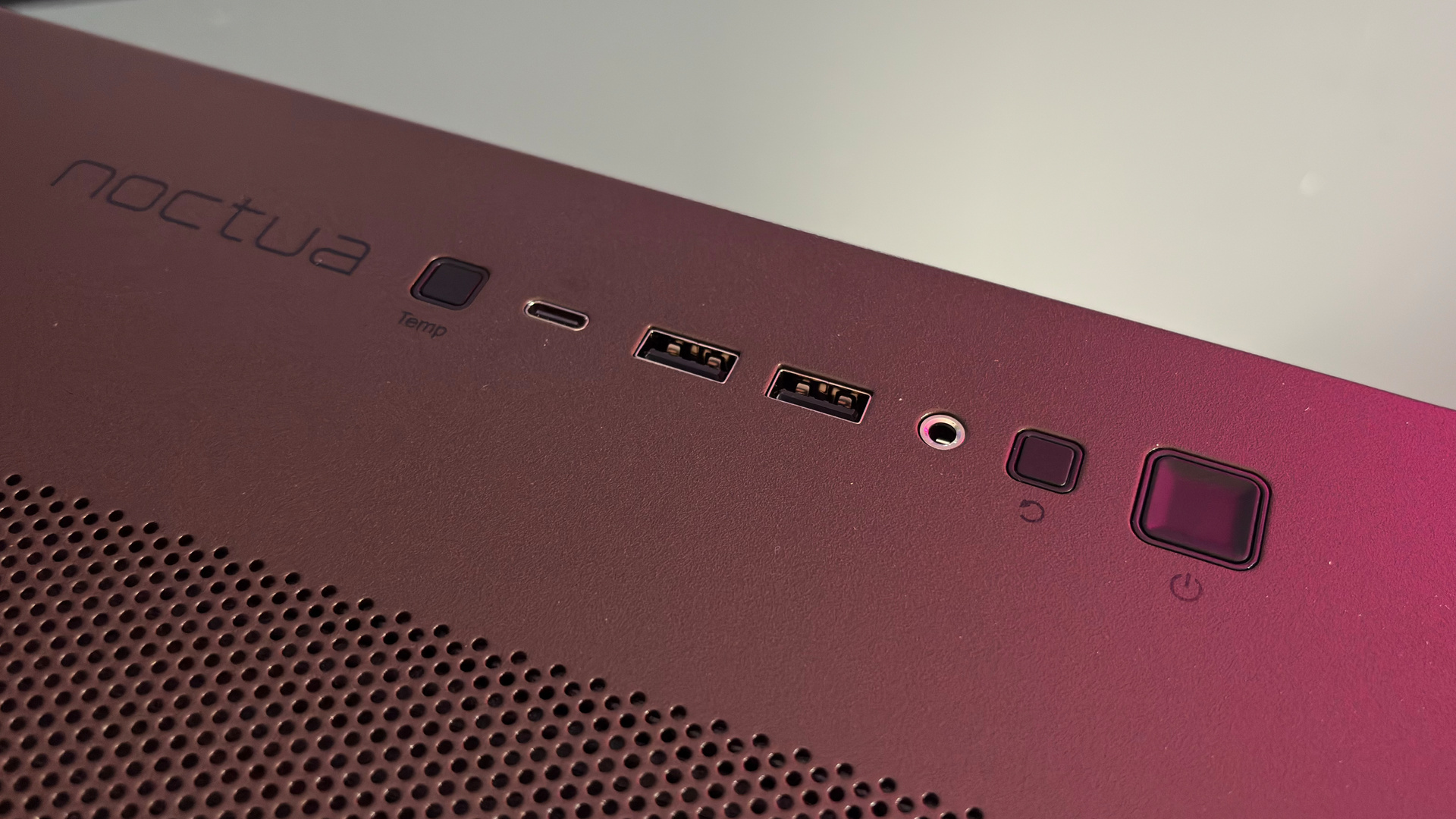 The Antec Flux Pro Noctua Edition on a desk with various parts disassembled.