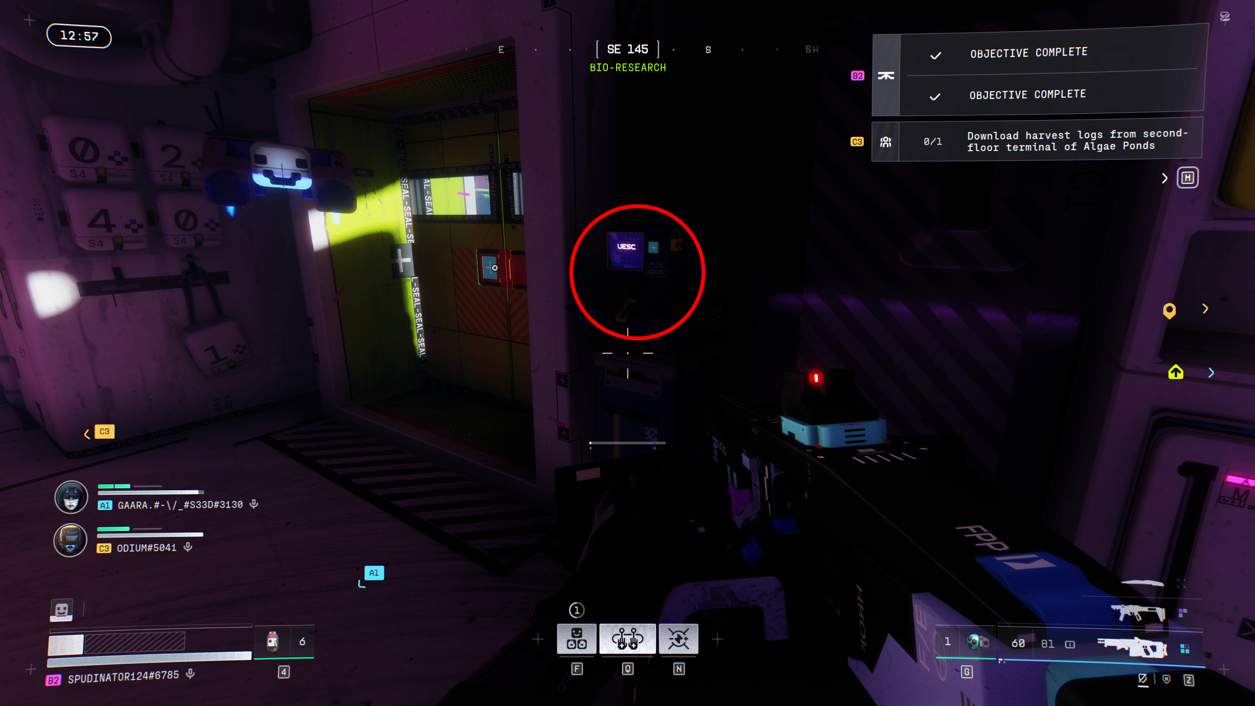 Marathon Introducing Traxus: A player looking at a blue terminal in a dark room, highlighted with a red circle.