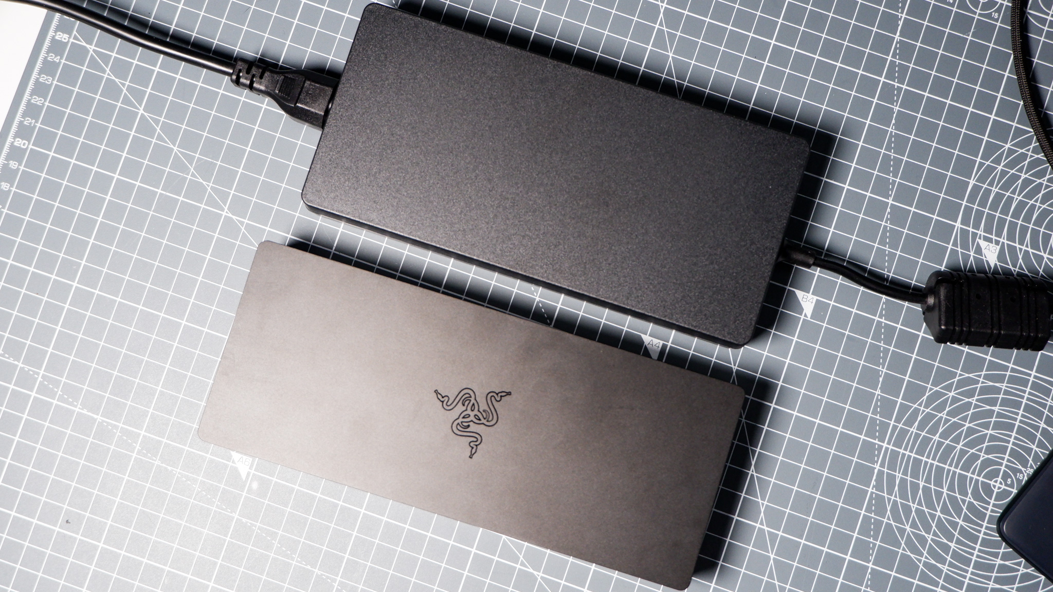 The Razer Thunderbolt 5 Dock on a desk with the RGB enabled and an SSD installed.