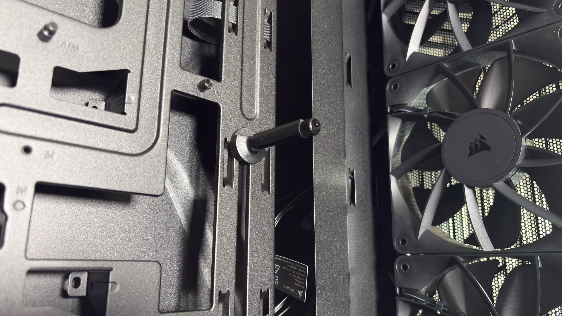 A Corsair PC case, the 3200D, on a desk with various panels removed and ready for a PC build.