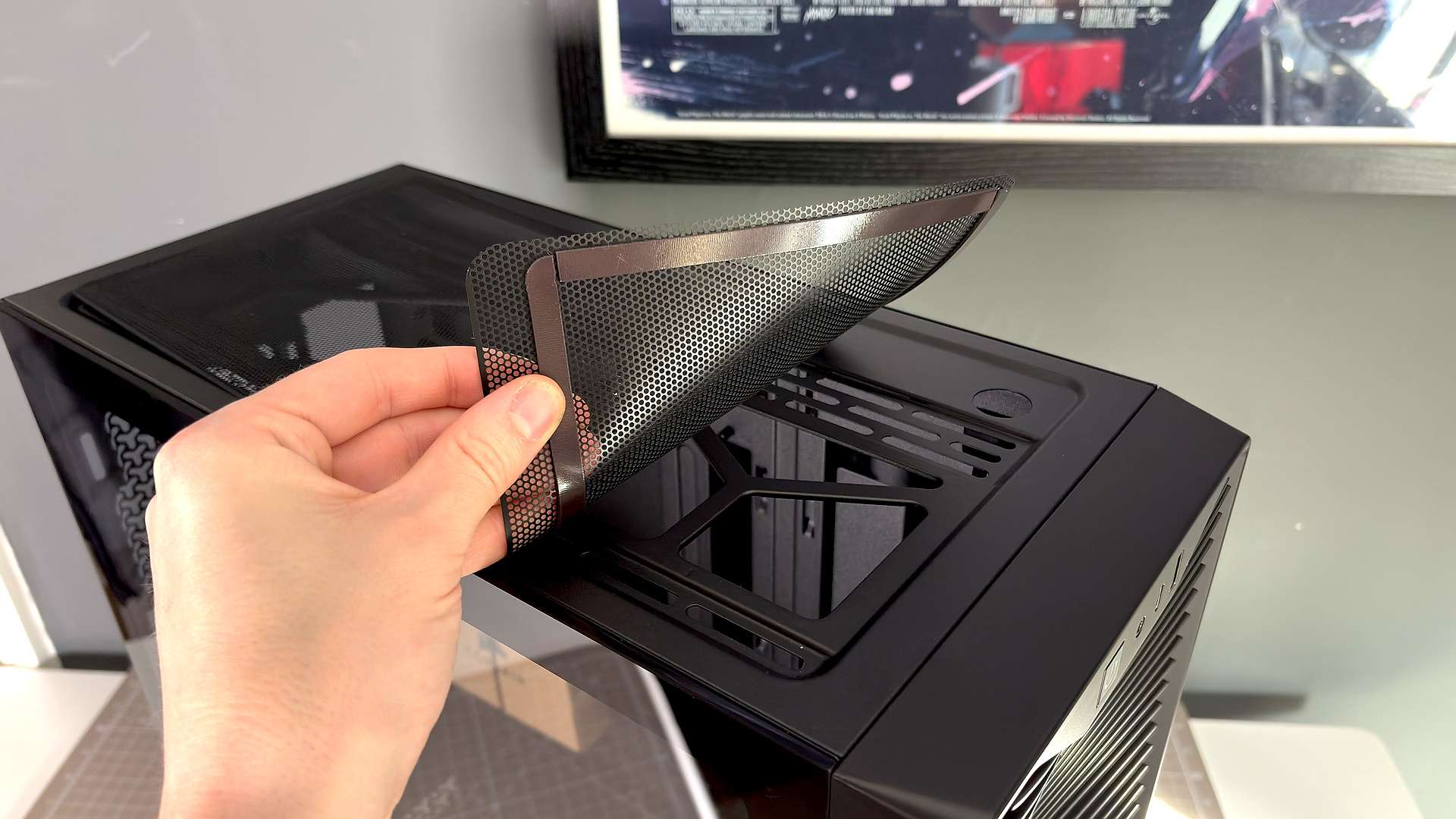 A Corsair PC case, the 3200D, on a desk with various panels removed and ready for a PC build.