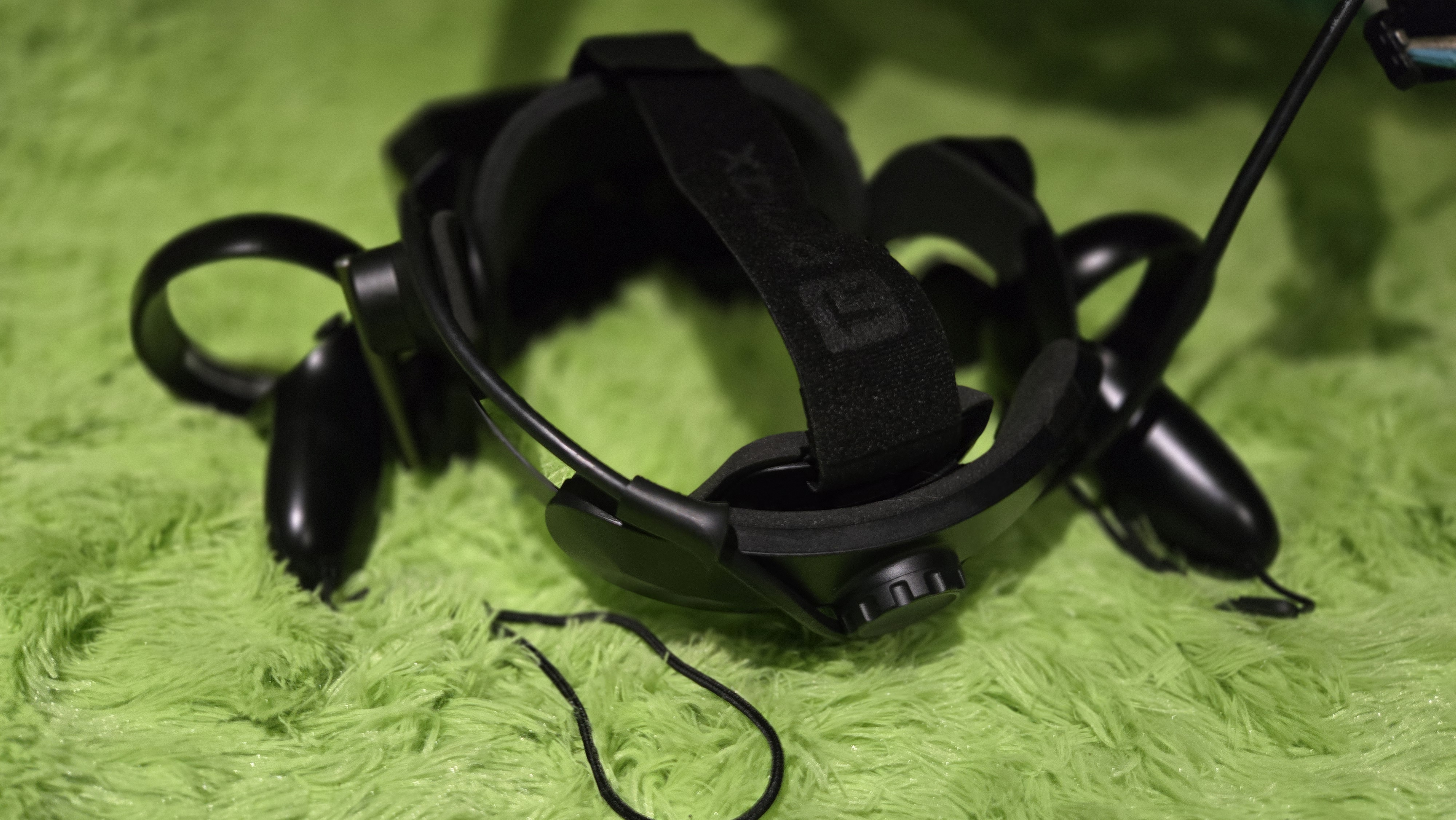 A Pimax Crystal Super virtual reality headset on a green background.