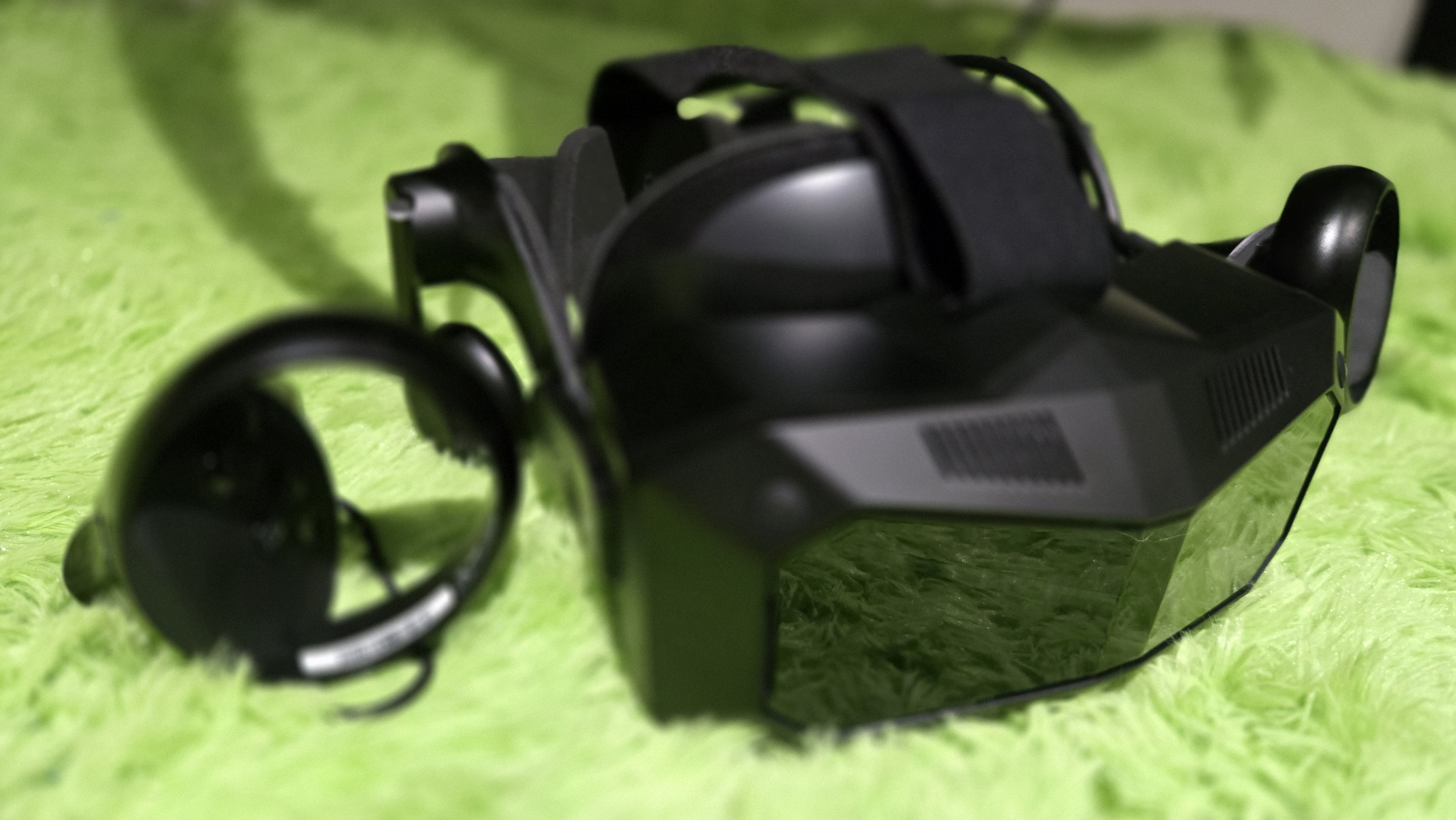 A Pimax Crystal Super virtual reality headset on a green background.