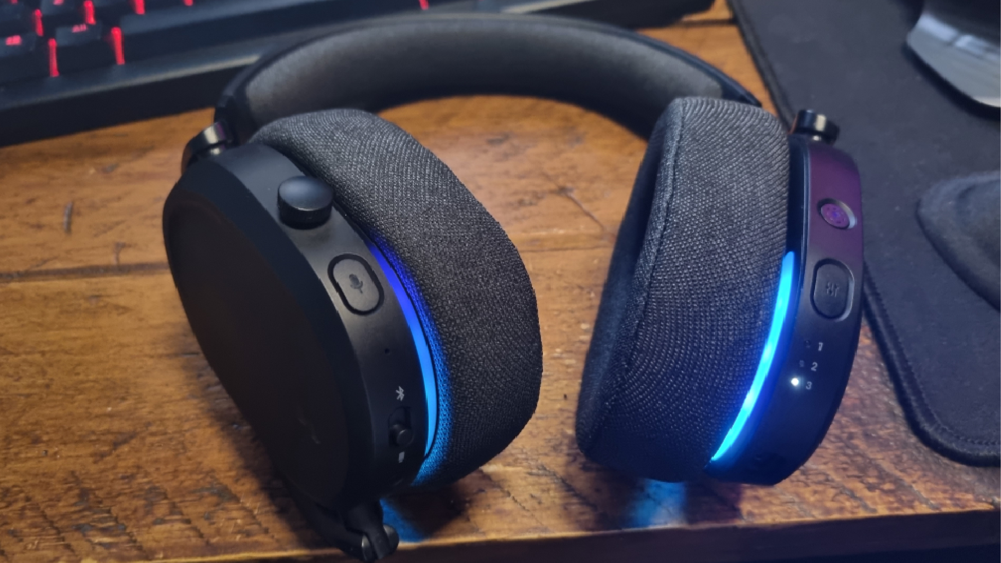 The rear earcup controls of the Fractal Design Scape, lit up in blue